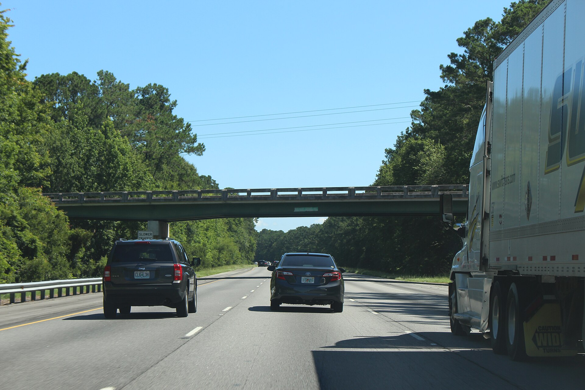 Traffic on northbound Interstate 95 passing beneath the Belfast Keller Road overpass in Richmond Hill, Bryan County, Georgia.